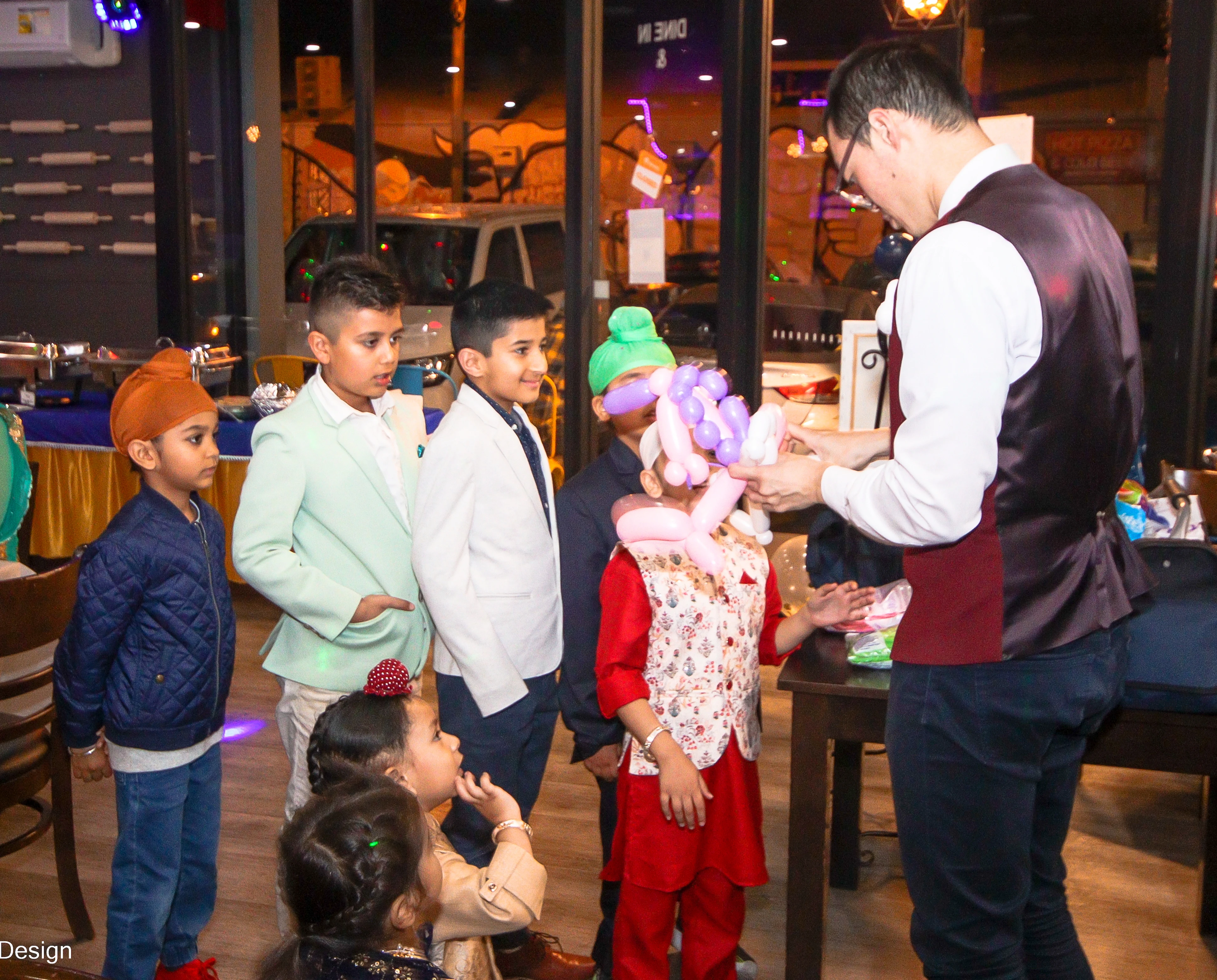 kids line up for a balloon and waiting for joe to make special animals