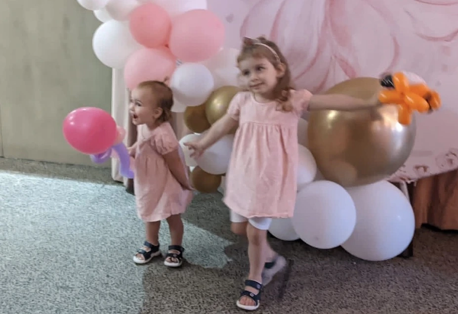 two happy kids with balloon animals