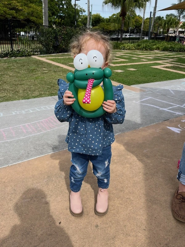 balloon animal frog and happy girl