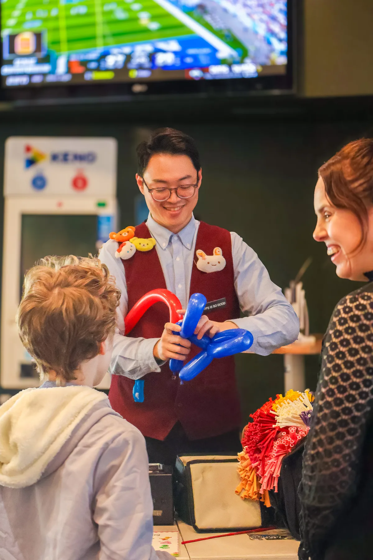 Kids queuing for balloon animals at a family day event