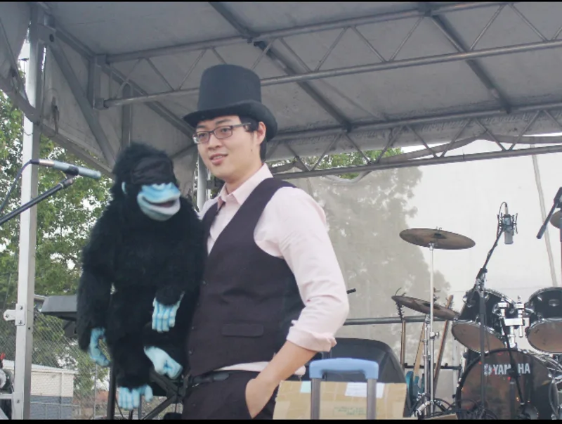 Joy Joe with a child holding a balloon and a puppet