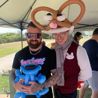 balloon twisting hat and a happy client