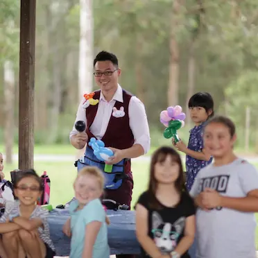 balloon twister surrounded by children